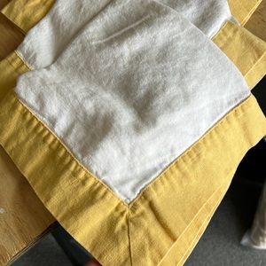 Set of 4 Pottery Barn linen dinner napkins with yellow border.